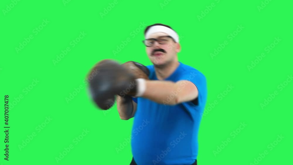Male comedic athlete in boxing gloves strikes the enemy. Male comedic athlete in boxing gloves strikes the enemy.
