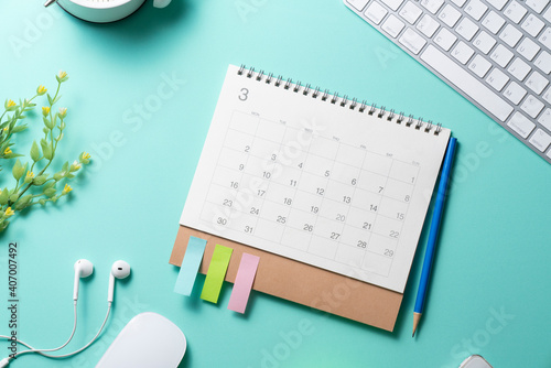close up of calendar and computer or notebook keyboard on the green table background, planning for business meeting or travel planning concept