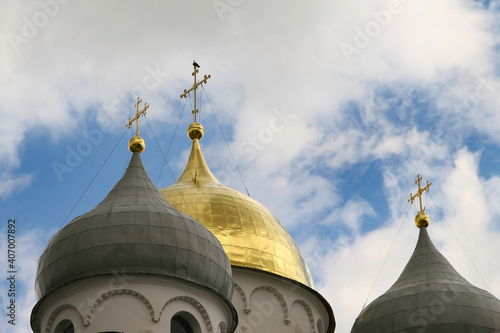 Church domes with Orthodox crosses against the background of the cloudy sky. photo