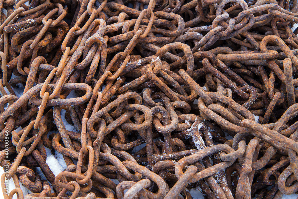 Old rusty metal chains. The chains are in the snow. Old rusty metal chains. The chains are in the snow.