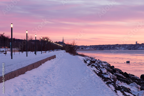 Beautiful Samuel-De Champlain walkway along the St. Lawrence River seen during a colourful winter dawn, Sillery area, Quebec City, Quebec, Canada © Anne Richard