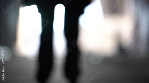Male silhouette going to bright light. Man  in underground go to the future. Male' foot go to light. The shadows of the feet walk to light. Exit and depression concept.