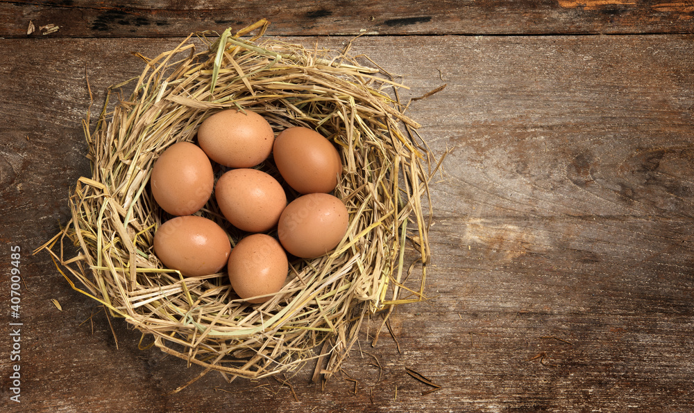 Top view fresh eggs on nest on old wooden background. Top view fresh eggs on nest on old wooden background.
