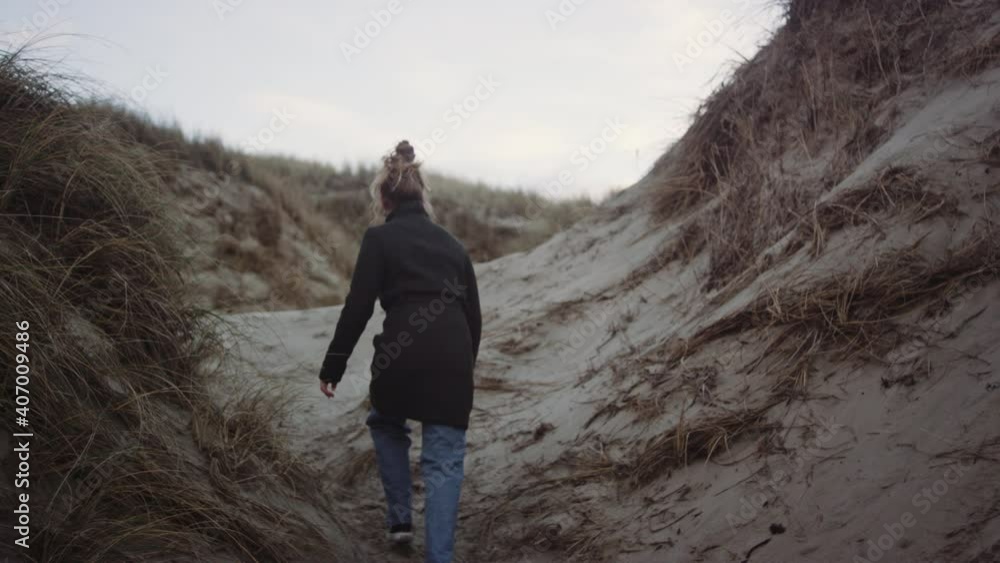 Redheaded Teenage Girl In Black Coat On Beach Redheaded Teenage Girl In Black Coat On Beach