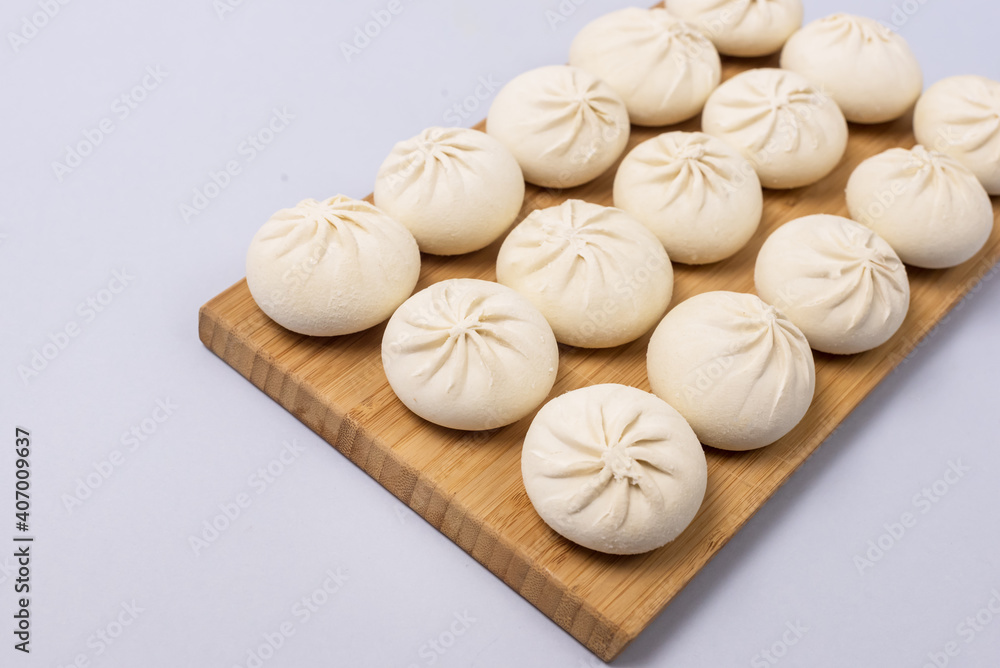 Raw and Frozen Homemade Pelmeni on Wooden Tray on Blue Background Horizontal Russian Cuisine Raw and Frozen Homemade Pelmeni on Wooden Tray on Blue Background Horizontal Russian Cuisine
