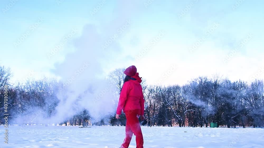 Unrecognisable person pouring hot water up in the sky, sunny winter day