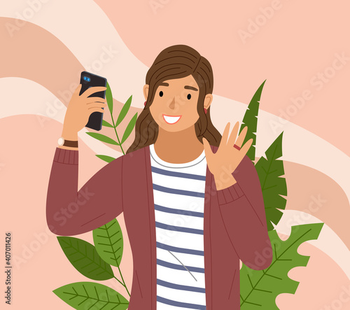 Young female character makes a selfie on the background of plants. A beautiful girl uses the phone to take a photo. A woman uses her smartphone to preserve the memory of the place she visited