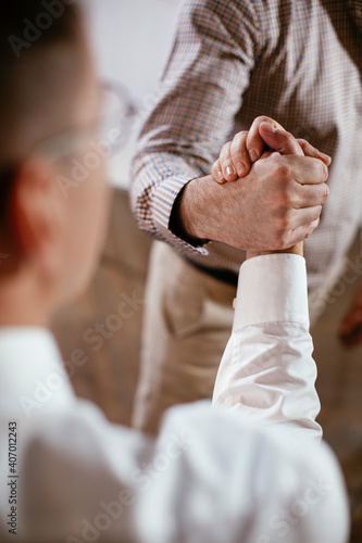 Close up of men handshake in office. Successful teamwork. Business people in office