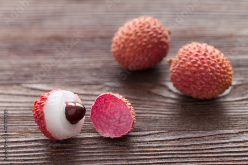 three lychees on a wooden table