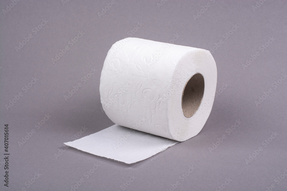 Roll of toilet paper on a gray background.