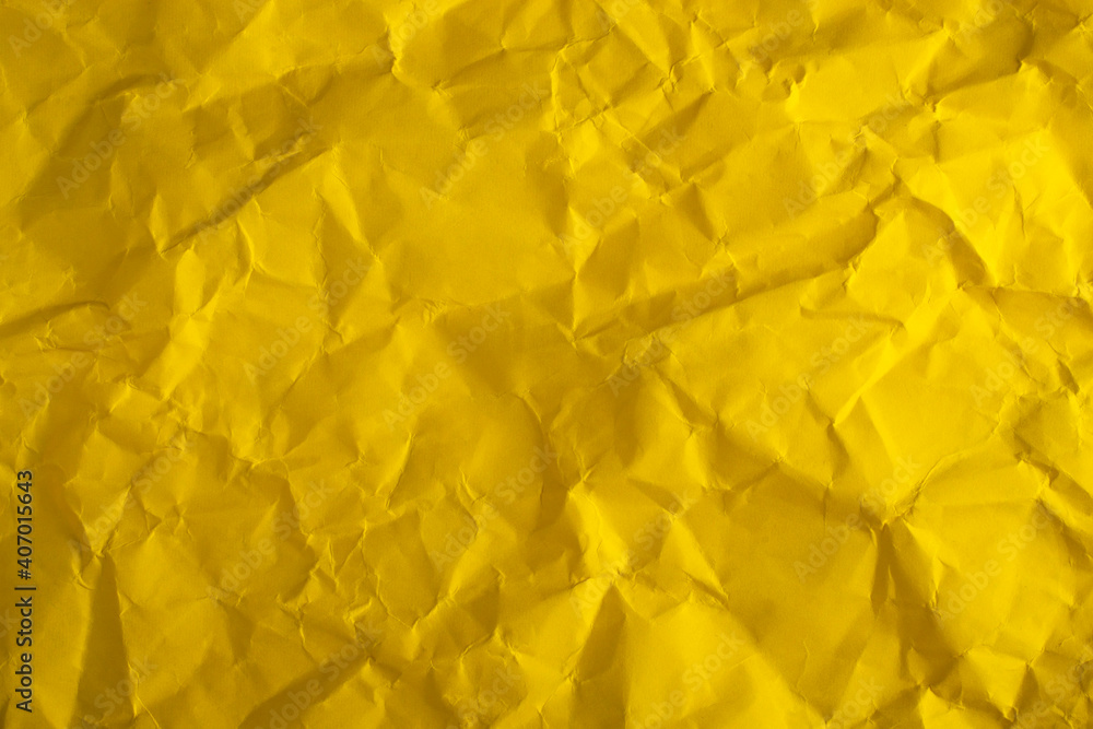 Yellow crumpled paper close-up. Abstract background. Yellow crumpled paper close-up. Abstract background.