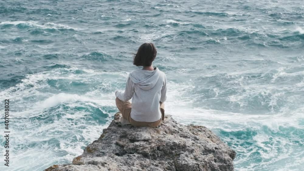 Young beautiful woman enjoy the sound of the waves. Get in touch with spiritual side Relax body and mind in nature outdoors. Slow Motion 240 FPS. Young beautiful woman enjoy the sound of the waves. Get in touch with spiritual side Relax body and mind in nature outdoors. Slow Motion 240 FPS.