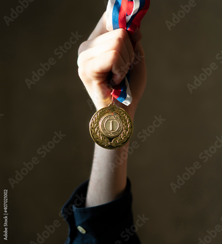 a campion's hand holding a golden medal, simple winner lucky concept