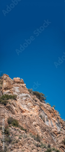 Wild goats over the rocks under clear sky