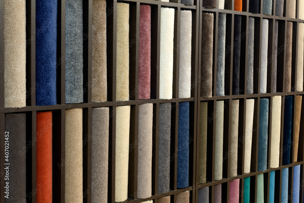 Samples of colored carpets at the stand. Various carpet designs for the interior. Samples of colored carpets at the stand. Various carpet designs for the interior.