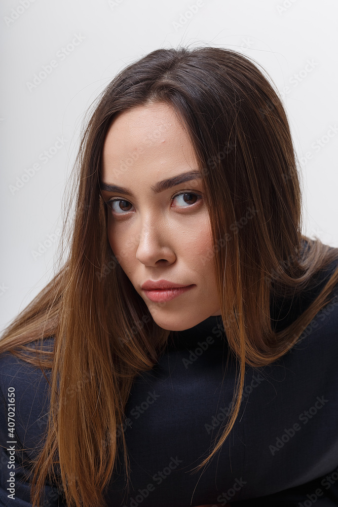 portrait of young attractive asian woman with long flowing hair in dark blue clothes, isolated on white studio background. skinny pretty female posing on cyclorama. model tests of beautiful lady portrait of young attractive asian woman with long flowing hair in dark blue clothes, isolated on white studio background. skinny pretty female posing on cyclorama. model tests of beautiful lady