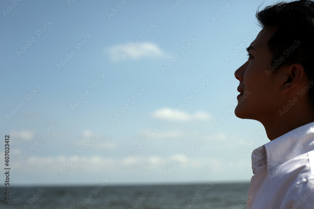 Portrait of Young man standing on seaside