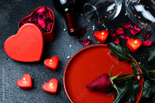 Valentine's day concept. Romantic evening, black background, red candle, top view.