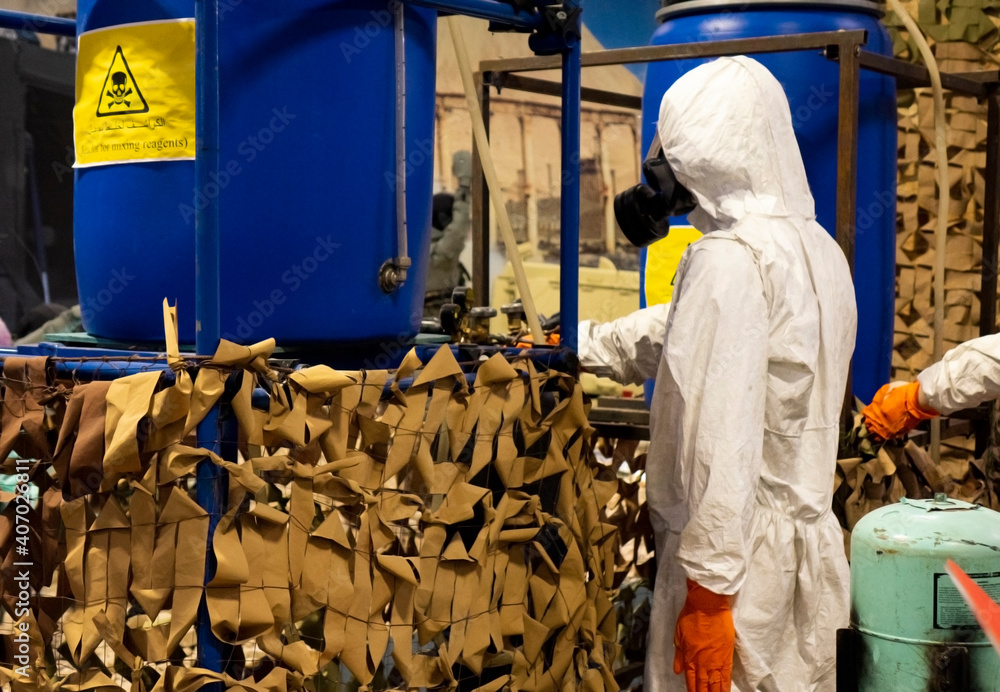 People in protective suits in the laboratory for the production of chemical and biological weapons.
