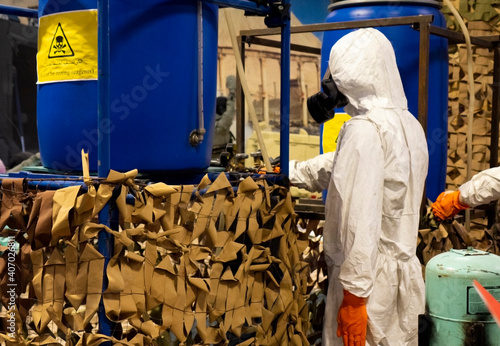 Obraz na płótnie People in protective suits in the laboratory for the production of chemical and biological weapons. w salonie