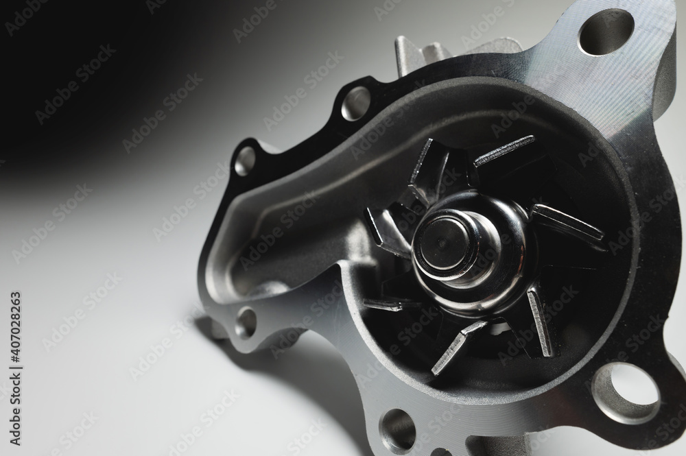 Engine coolant pump. New spare part on a contrasting gradient background for car services Engine coolant pump. New spare part on a contrasting gradient background for car services
