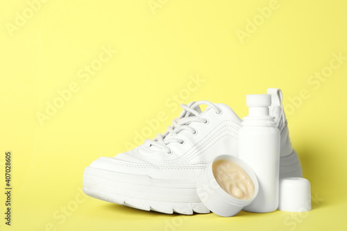 Composition with stylish footwear and shoe care accessories on yellow background