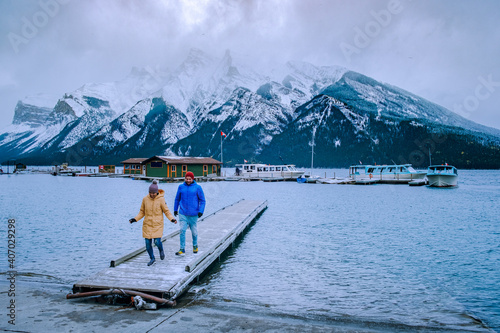 Minnewanka lake in Canadian Rockies in Banff Alberta Canada with turquoise water is surrounded by coniferous forests. Lake Two Jack in the Rocky Mountains of Canada. couple hiking by the lake Banff