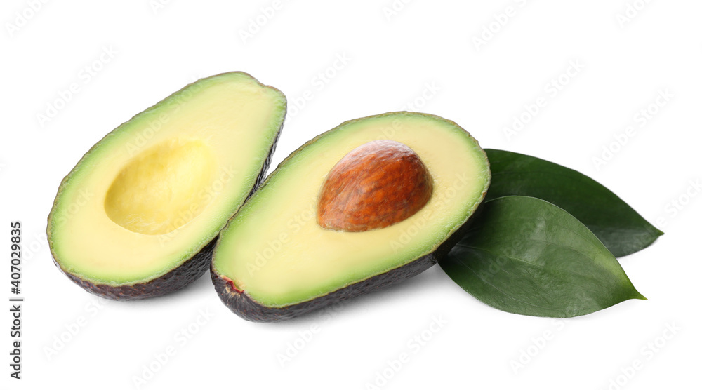 Cut hass avocado and green leaves on white background Cut hass avocado and green leaves on white background