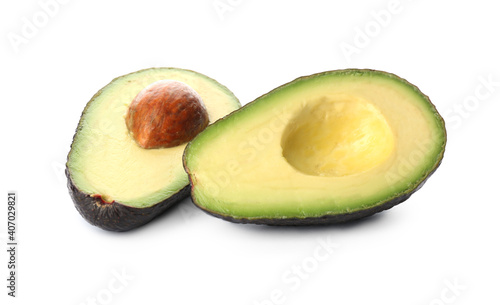 Cut ripe avocado with pit on white background