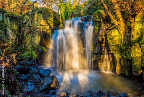 Fototapeta Naklejka Na Ścianę i Meble -  A long exposure view of a stepped waterfall section at Lumsdale on Bentley Brook, Derbyshire, UK