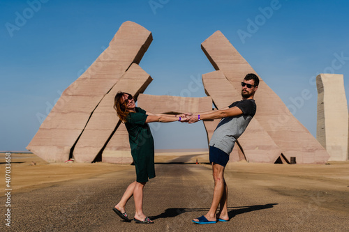 Couple stand near huge Gate of Allah, Ras Mohammed national park in Egypt. Desert
