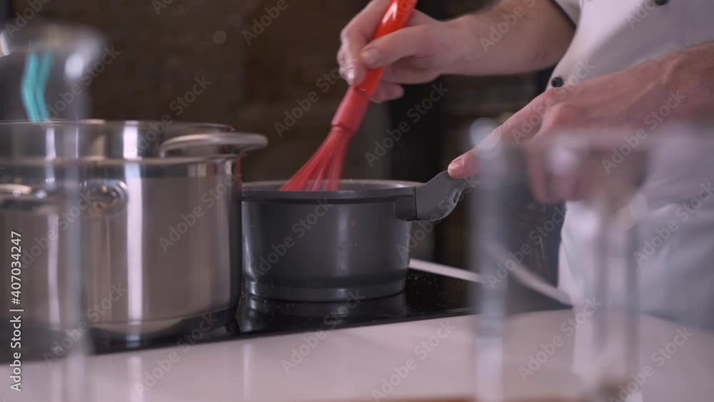 Professional Pastry Chef, Baker in a Restaurant Kitchen is preparing a Dessert. Confectioner at work. Chef cooking in Kitchen. Delicious healthy Food. Modern Cuisine. Slow motion Close up