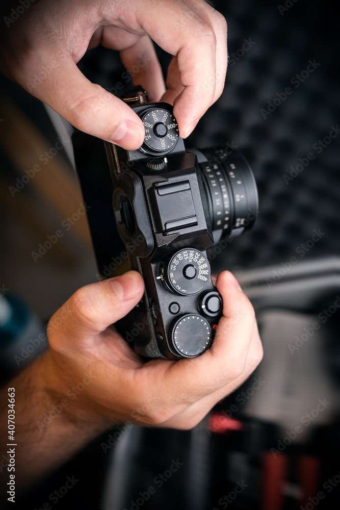 Hands holding a camera setting the photography Hands holding a camera setting the photography