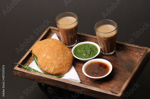 Indian snakes food kachouri or kachoudi kachori served with masala or cutting chai tamarind and mint chutney photo