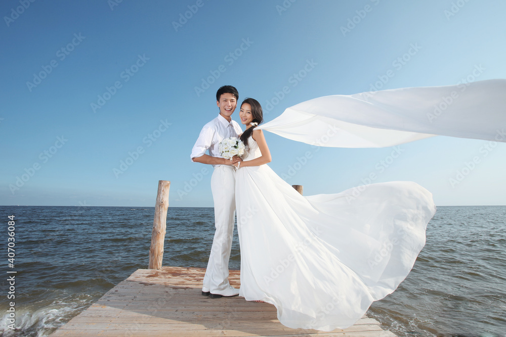 Young Couple in Wedding Dress on beach Young Couple in Wedding Dress on beach