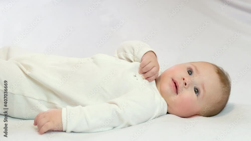 baby on a white background lies smiling. selective focus baby on a white background lies smiling. selective focus