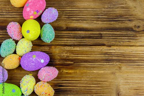 Easter eggs on rustic wooden background. Top view, copy space