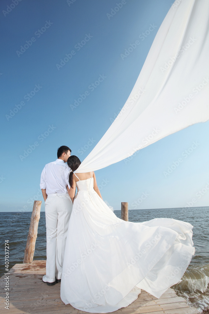 Young Couple in Wedding Dress on beach Young Couple in Wedding Dress on beach