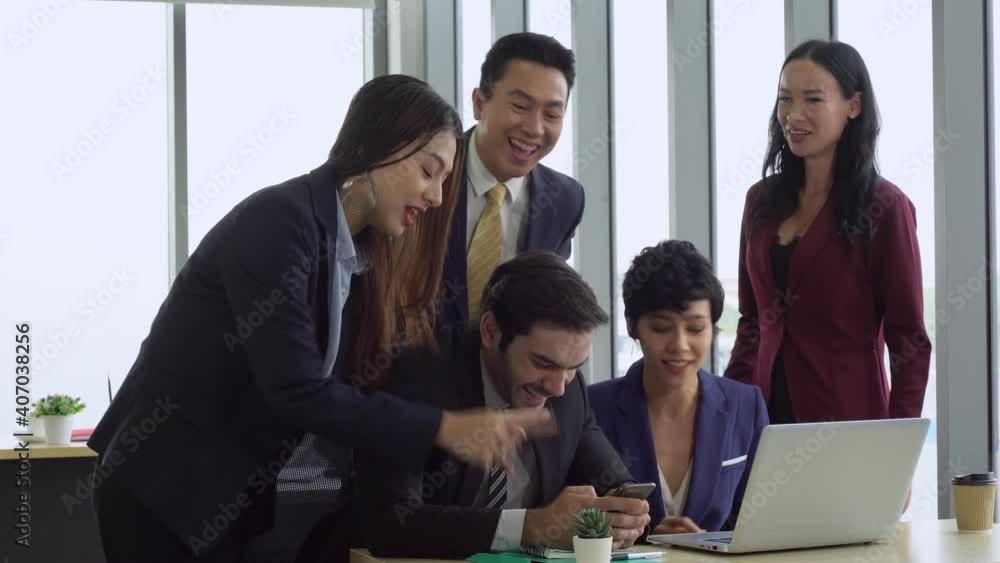 young caucasian man get good news and celebrate with multiracial colleagues in office. diversity in business concept young caucasian man get good news and celebrate with multiracial colleagues in office. diversity in business concept