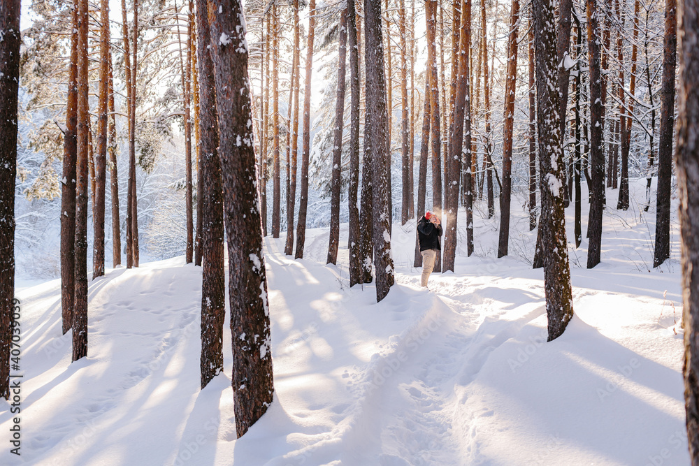Young man takes photos in winter forest Young man takes photos in winter forest