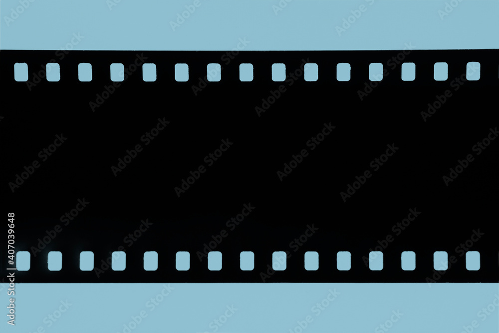 Strip of old celluloid film, Old photographic film, negative on blue background