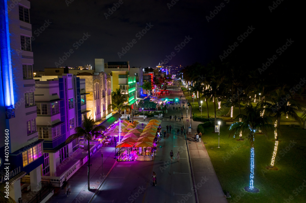 Ocean Drive Miami Beach night neon lights and tourists walking