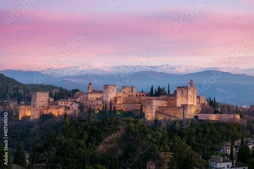 The Alhambra castle under a pink sky.