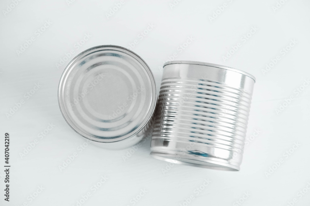Two aluminum closed metal cans on a white table. Top view. Copy, empty space for text Two aluminum closed metal cans on a white table. Top view. Copy, empty space for text