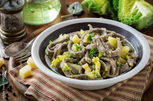 Homemade Pizzoccheri alla Valtellinese - buckwheat pasta with potatoes, savoy cabbage and cheese typical of Valtellina, Italian cuisine of Lombardy region photo