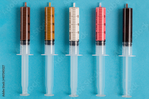 syringes stuffed with milk and white chocolate, caramel, strawberry and dark chocolate 