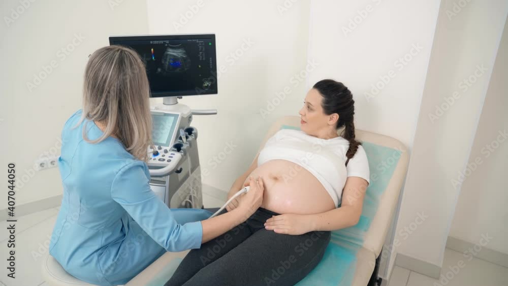 Doctor doing screening of pregnant woman with ultrasound Doctor doing screening of pregnant woman with ultrasound