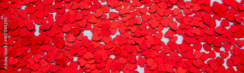Scattered glitter little red hearts banner. Valentines background