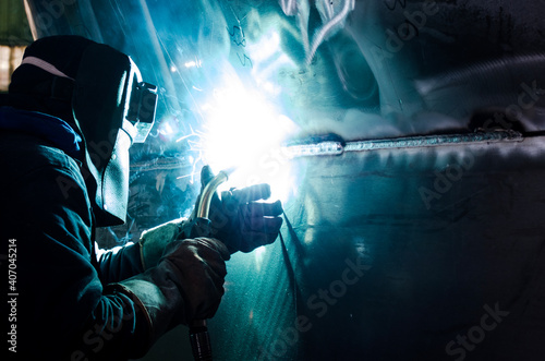 welder at work with aluminum welding