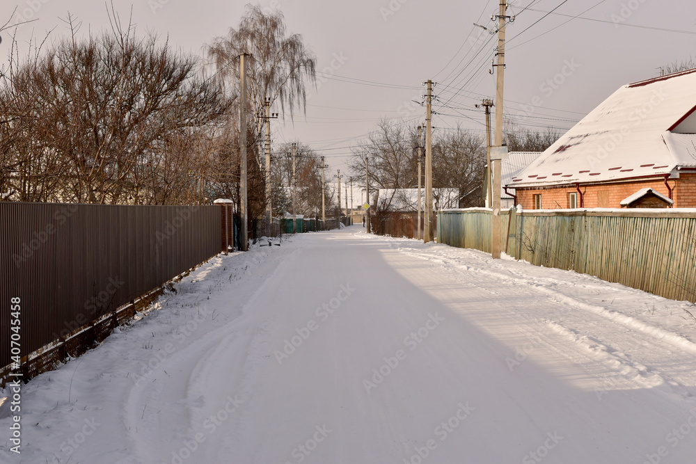 A rural street covered with snow.